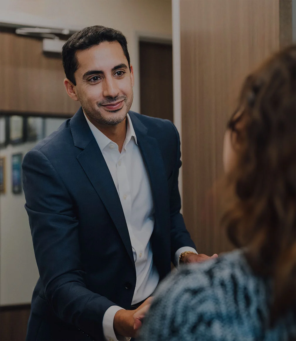 Dr. Dhir shaking the hand of a first time client. - Dr Robert Dhir in Webster, TX