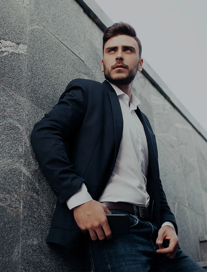 Man in suit leaning against a wall - Vasectomies in Webster Texas